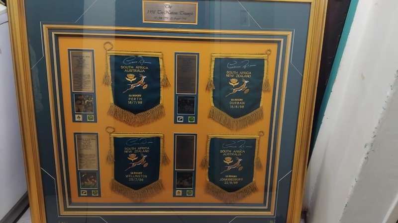 Framed sports memorabilia displays and commemorative plaques