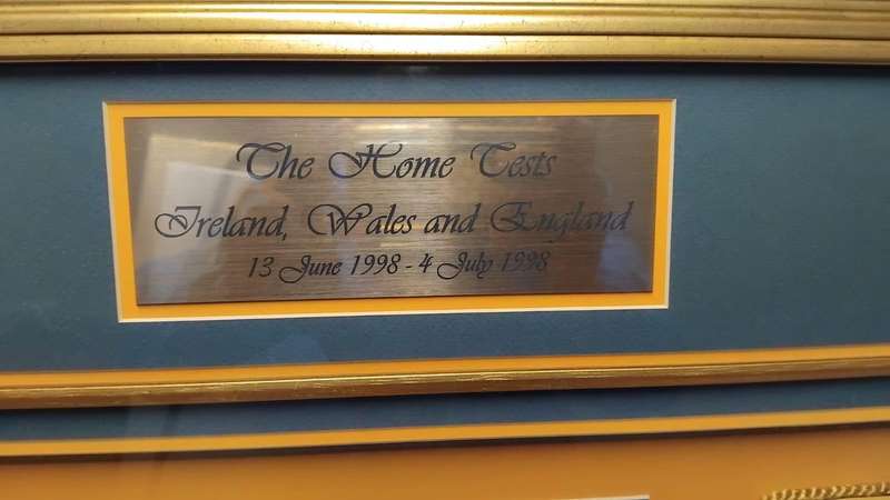 Framed sports memorabilia displays and commemorative plaques