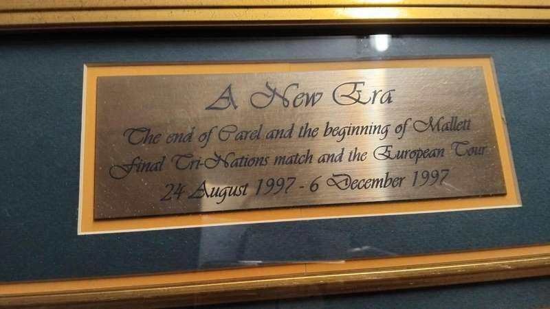Framed sports memorabilia displays and commemorative plaques