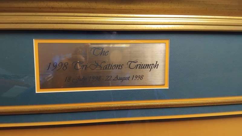 Framed sports memorabilia displays and commemorative plaques