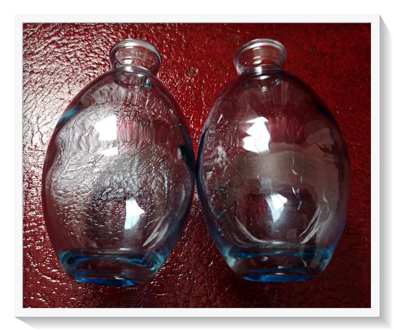 A Pair of clear blue glass bottles - Dimensions: 12cm by 7cm - Condition: New