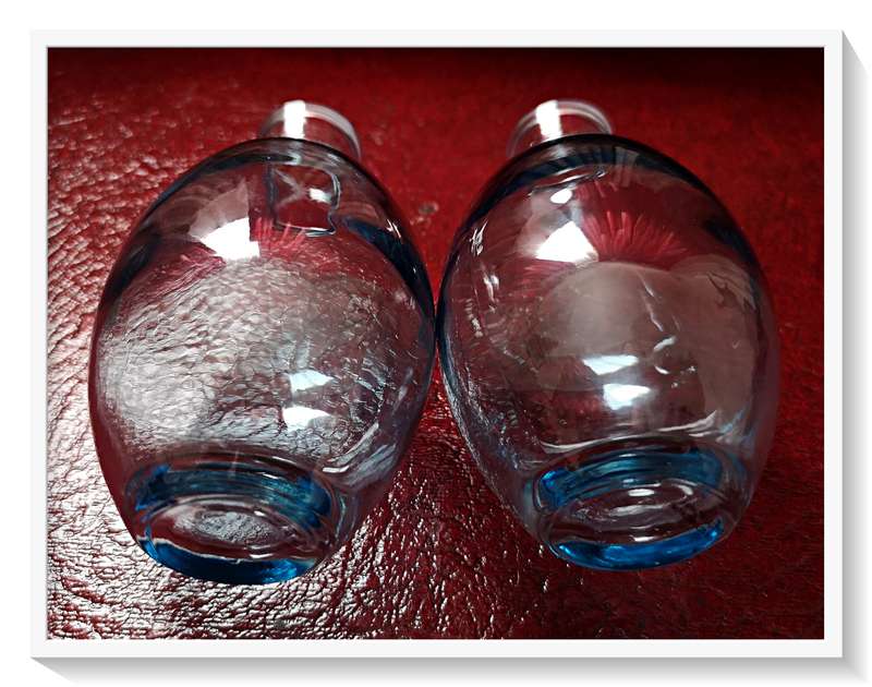 A Pair of clear blue glass bottles - Dimensions: 12cm by 7cm - Condition: New