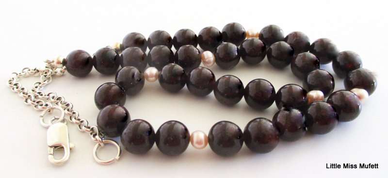 A Garnet and Pearl necklace on a sterling silver clasp and chain. 49cm adjustable to downsize