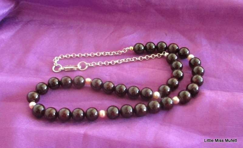 A Garnet and Pearl necklace on a sterling silver clasp and chain. 49cm adjustable to downsize