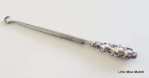 A hallmarked silver button hook