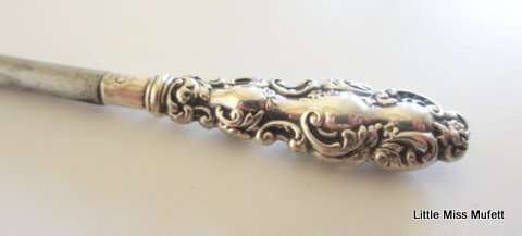 A hallmarked silver button hook