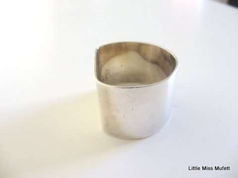 An interesting Sterling silver South African Norman Watson serviette ring.  41 Gram