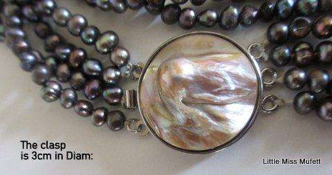 A BEAUTIFULLY TONED FRESH WATER PEARL 3 STRING BRACELET WITH A LARGE MOTHER OF PEARL CLASP