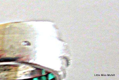 A WIDE STERLING SILVER RING WITH GREEN AND CLEAR STONES--Probably custom made