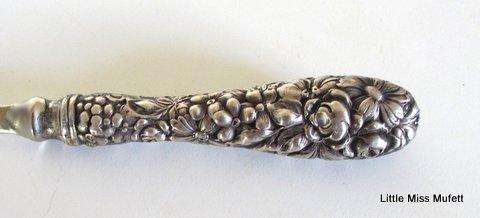 A Letter opener with a sterling silver handle in a leather cover.--Please read description