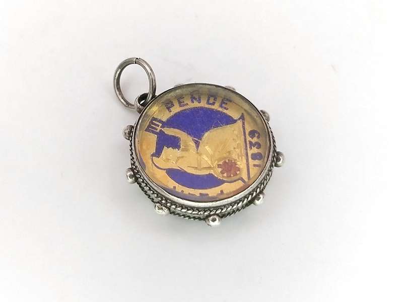 Victorian enamel coin pendant set in sterling silver