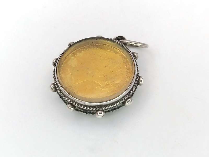 Victorian enamel coin pendant set in sterling silver