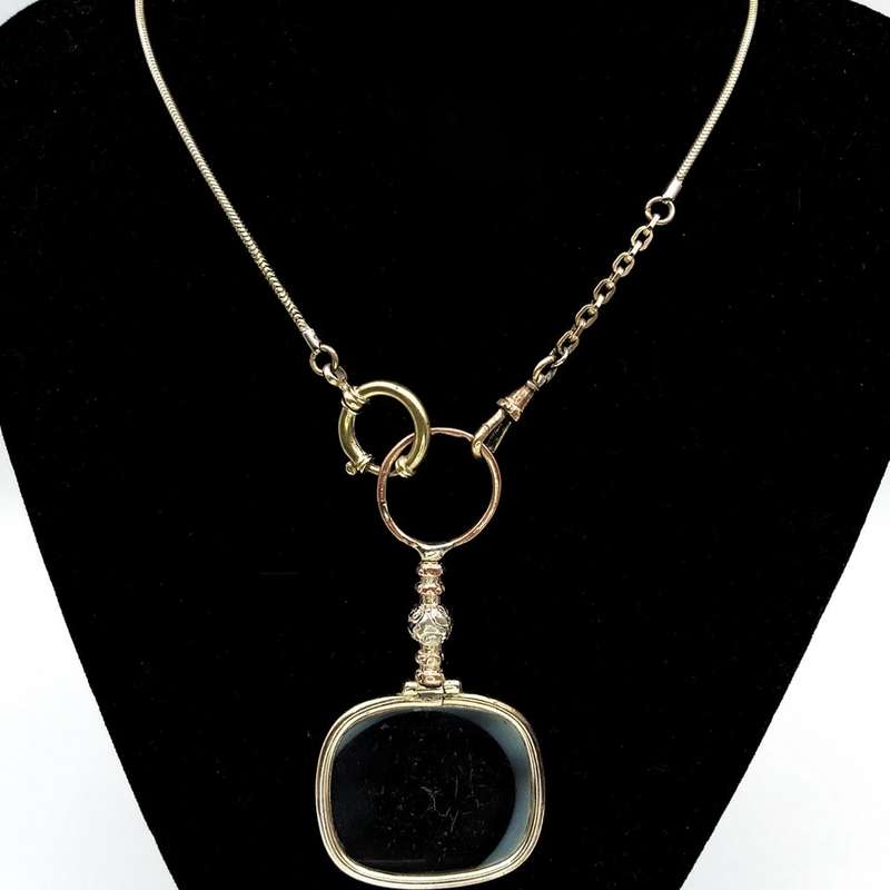 Antique gold plated quizzing glass on chain