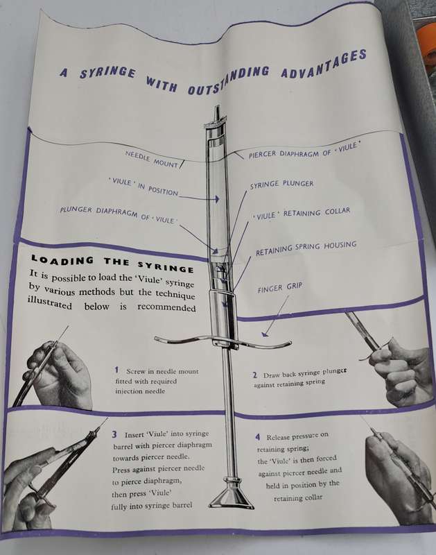 Boots viule syringe in a metal case with two glass containers with needles inside.