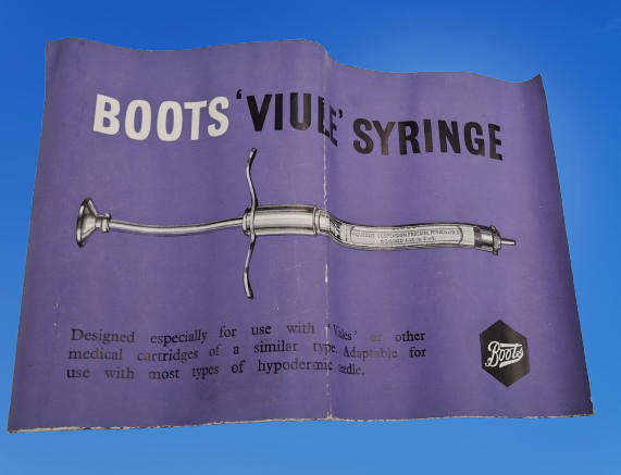 Boots viule syringe in a metal case with two glass containers with needles inside.