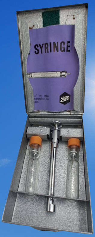 Boots viule syringe in a metal case with two glass containers with needles inside.