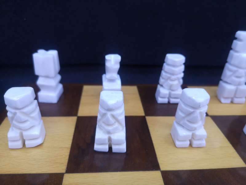 Black and yellow wood chess board with chess set