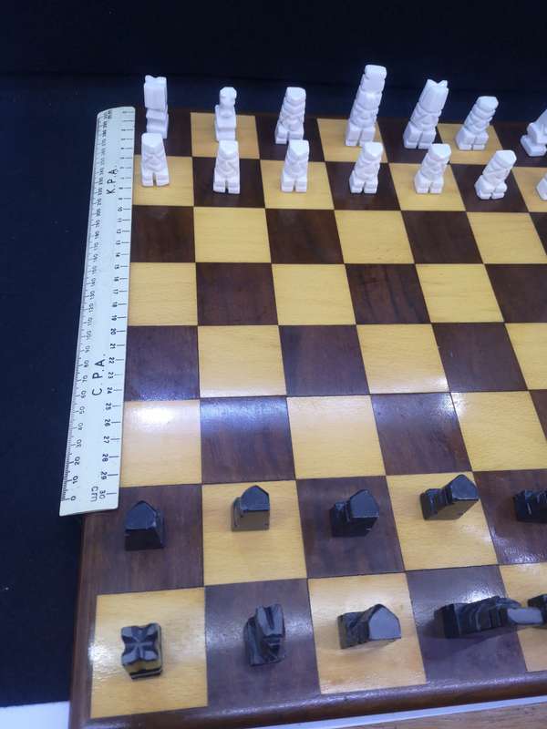 Black and yellow wood chess board with chess set