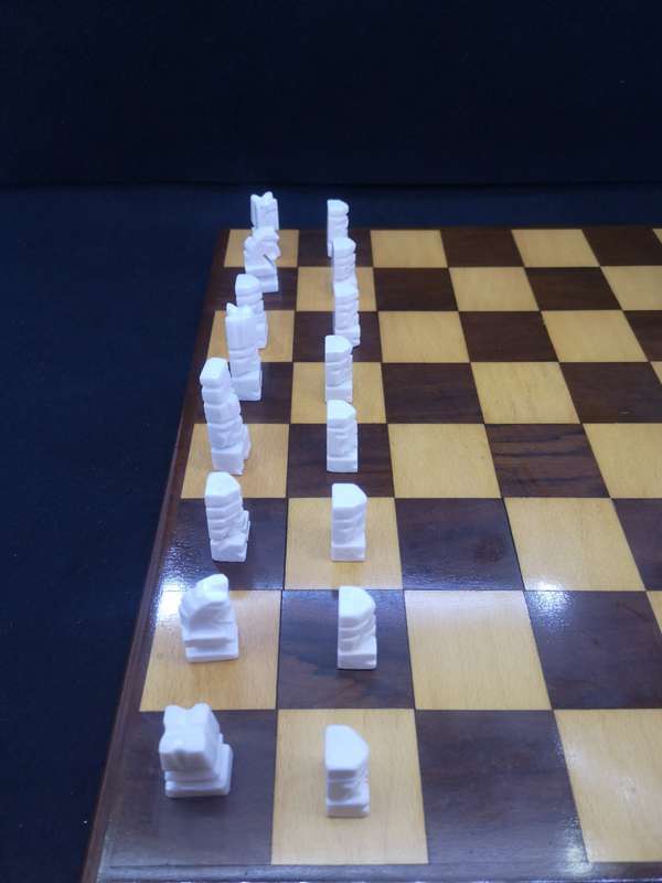 Black and yellow wood chess board with chess set