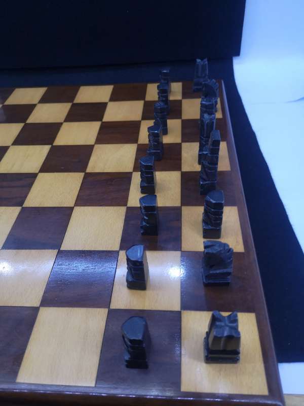 Black and yellow wood chess board with chess set