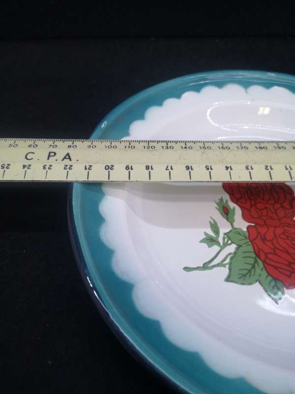 Old enamel plate with rose detail