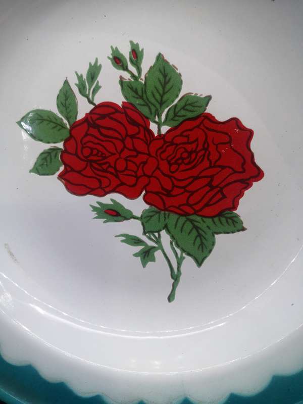 Old enamel plate with rose detail