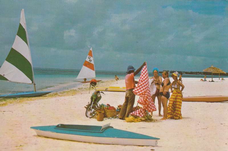 Post Card Mauritius - Trou Aux Biches Beach Interdite Canoes Sailboats Vendor selling goods to beac