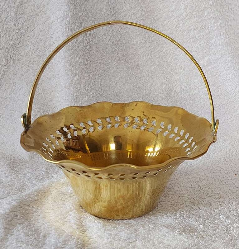 Decorative brass basket with swivel hande and pierced decoration