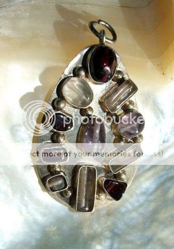 A lovely naive pendant set with 11 stones - amethyst and crystal.