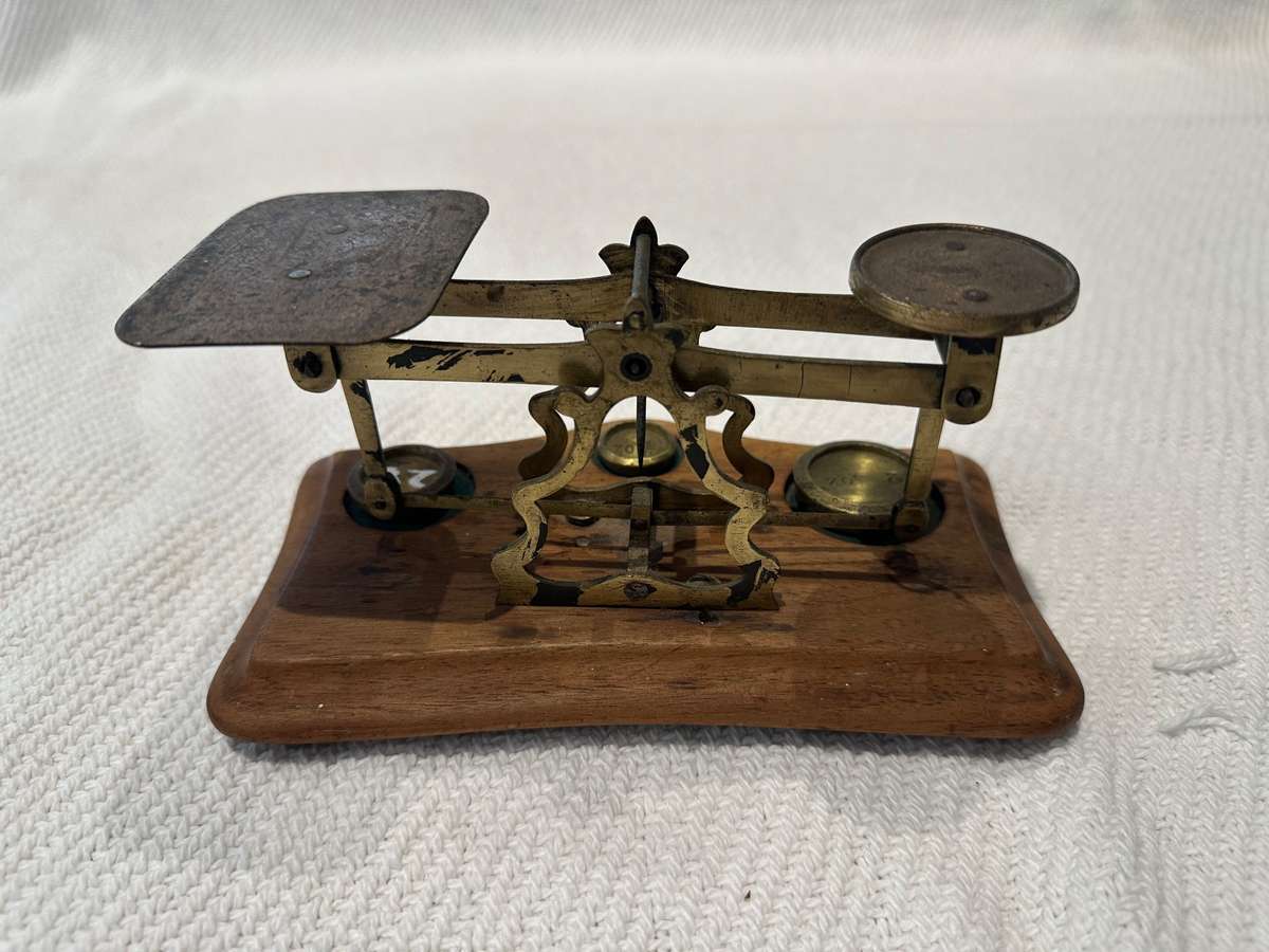 Vintage miniature balance scale on wooden base