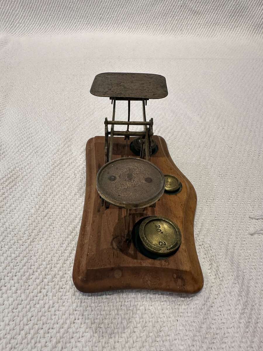 Vintage miniature balance scale on wooden base