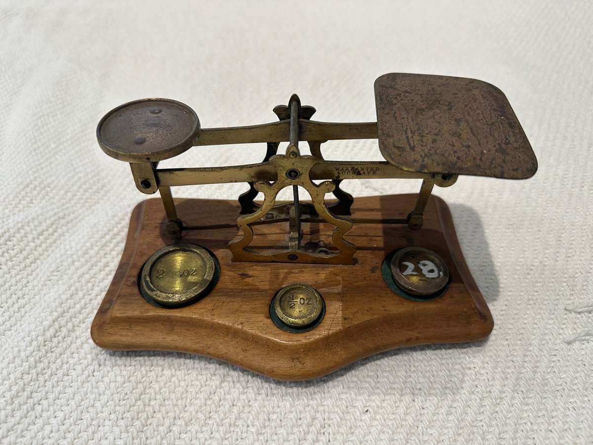 Vintage miniature balance scale on wooden base