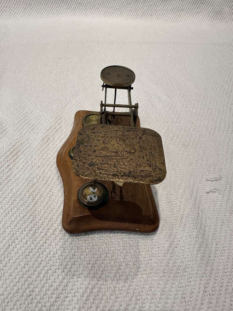 Vintage miniature balance scale on wooden base