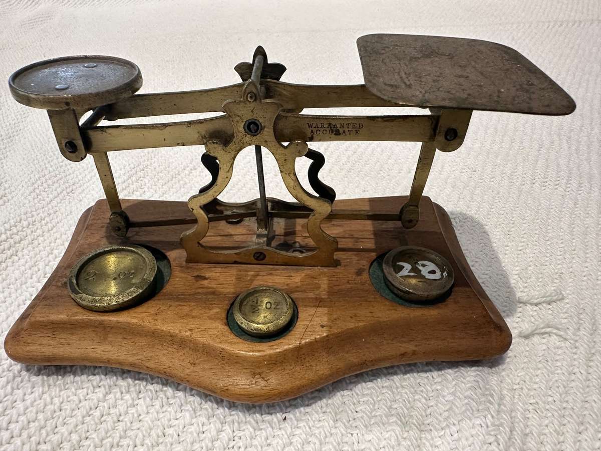 Vintage miniature balance scale on wooden base