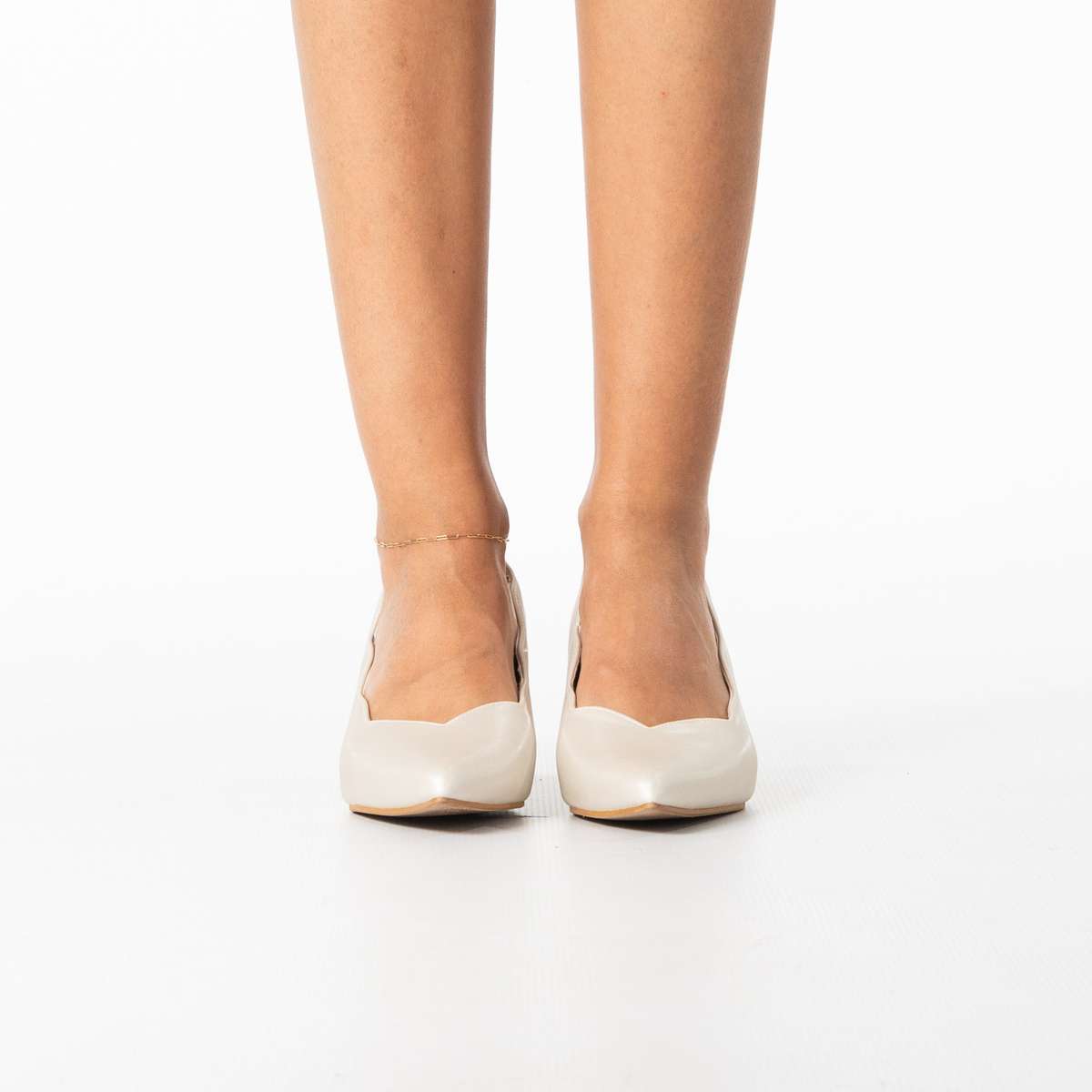 Enjoy women's sleek pointed heel with scalloped edge detail