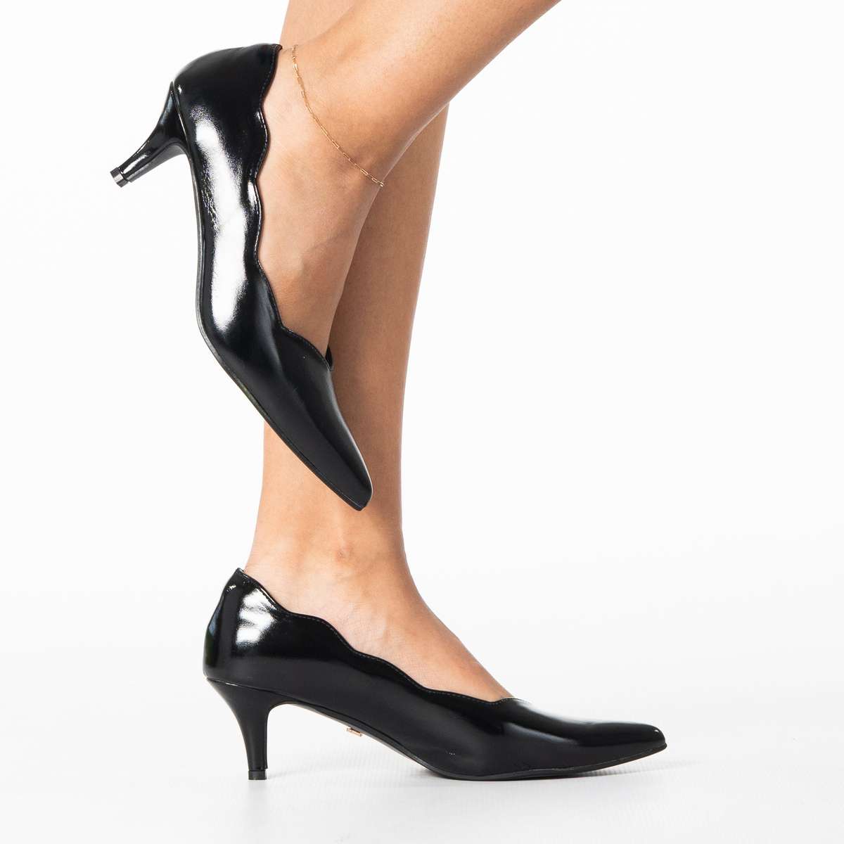 Enjoy women's sleek pointed heel with scalloped edge detail
