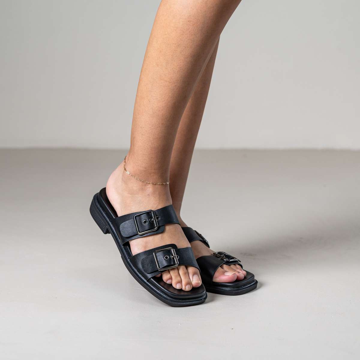 Brevyn slide sandal with wide strap and metal stud