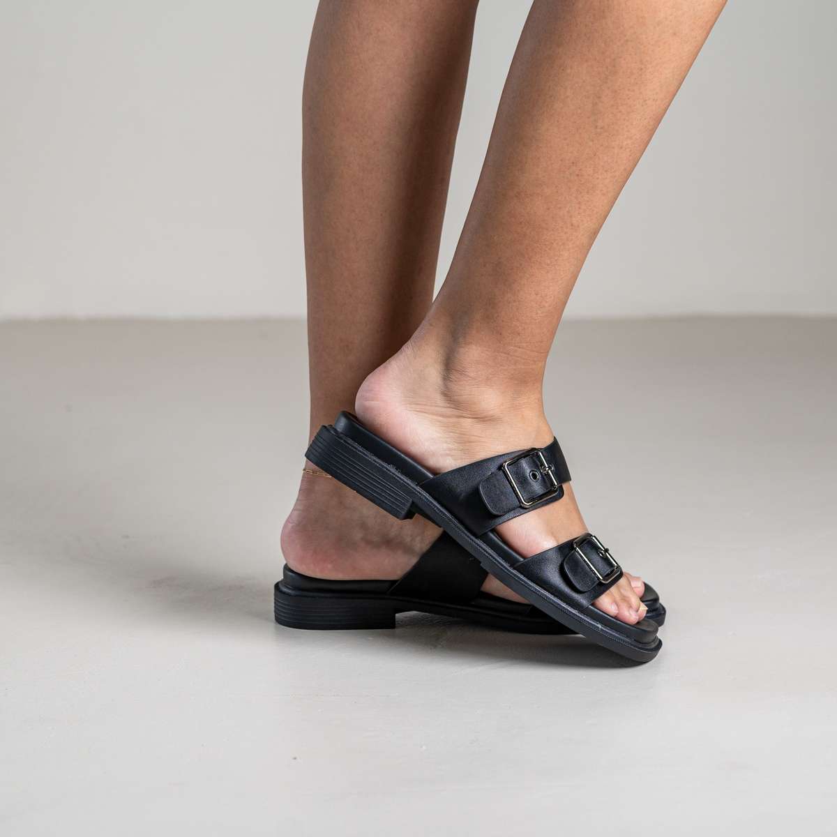 Brevyn slide sandal with wide strap and metal stud