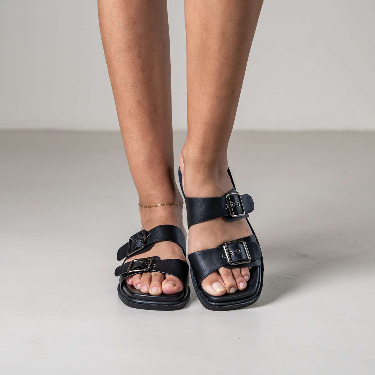 Brevyn slide sandal with wide strap and metal stud