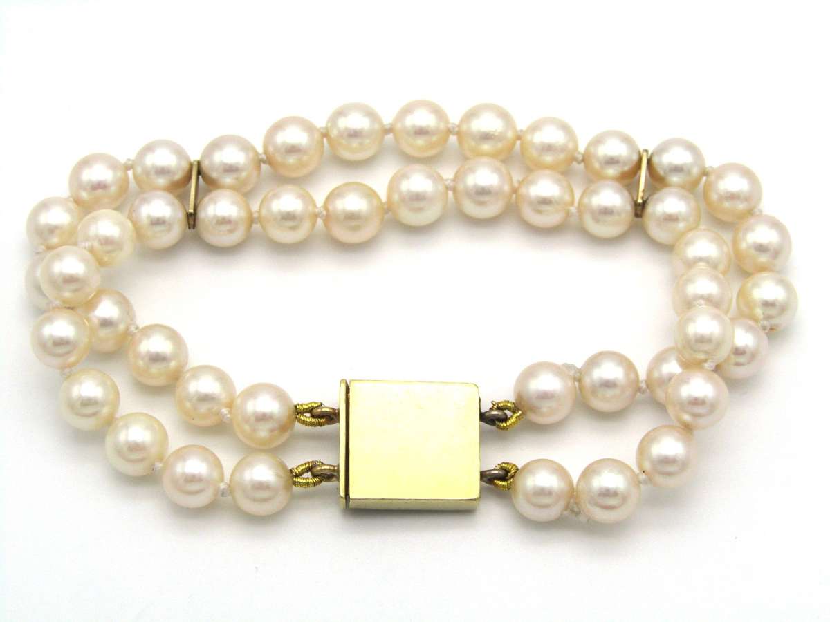 Mid-century, 18K gold double-strand cultured pearl, ruby, sapphire and emerald bracelet