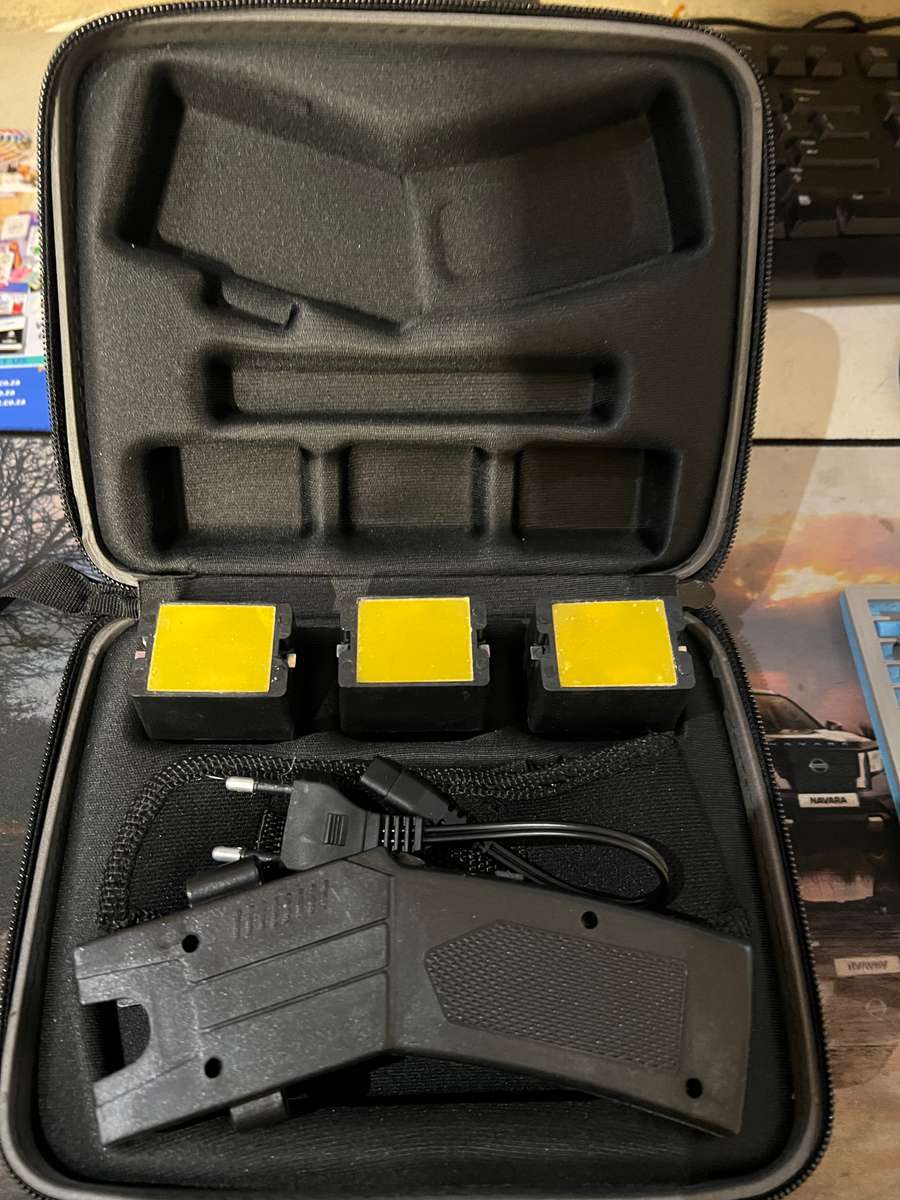 Taser 80KV self-defense shooting stun gun (ballistic taser-style device) in a hard-shell zippered...