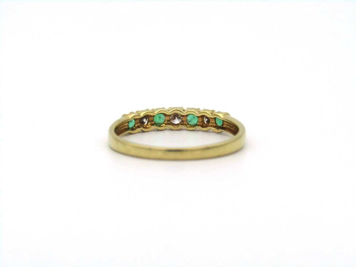 18K gold emerald and diamond ring.