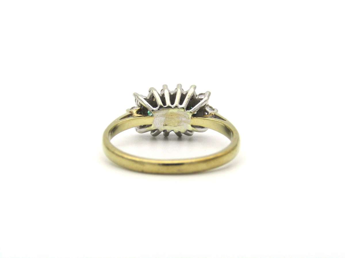 9K gold emerald and diamond ring.