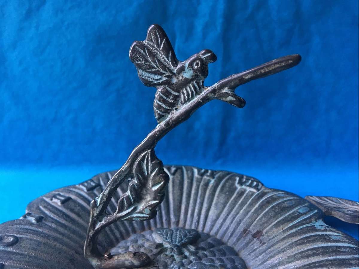 Vintage bronze sundial with dragonfly