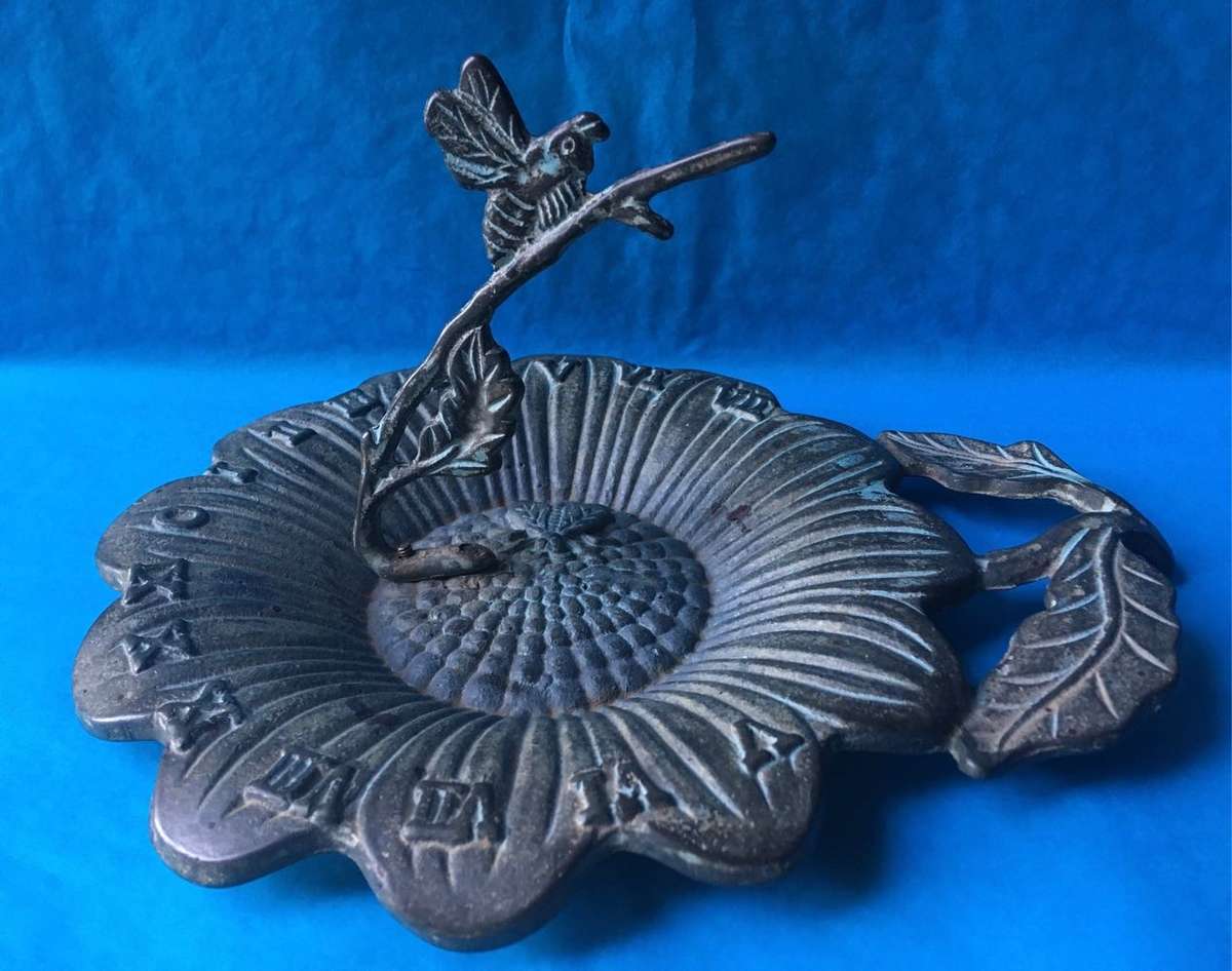 Vintage bronze sundial with dragonfly