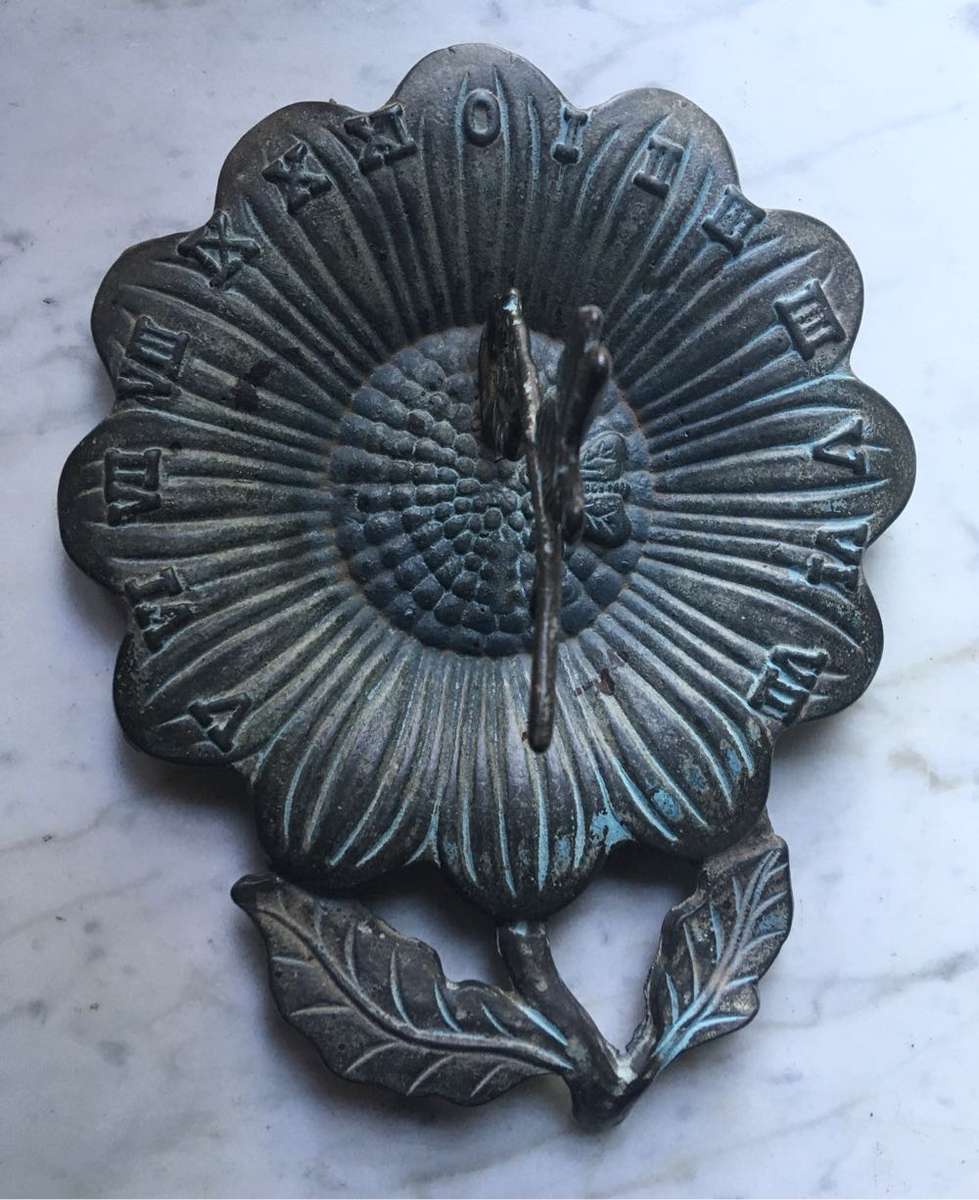 Vintage bronze sundial with dragonfly