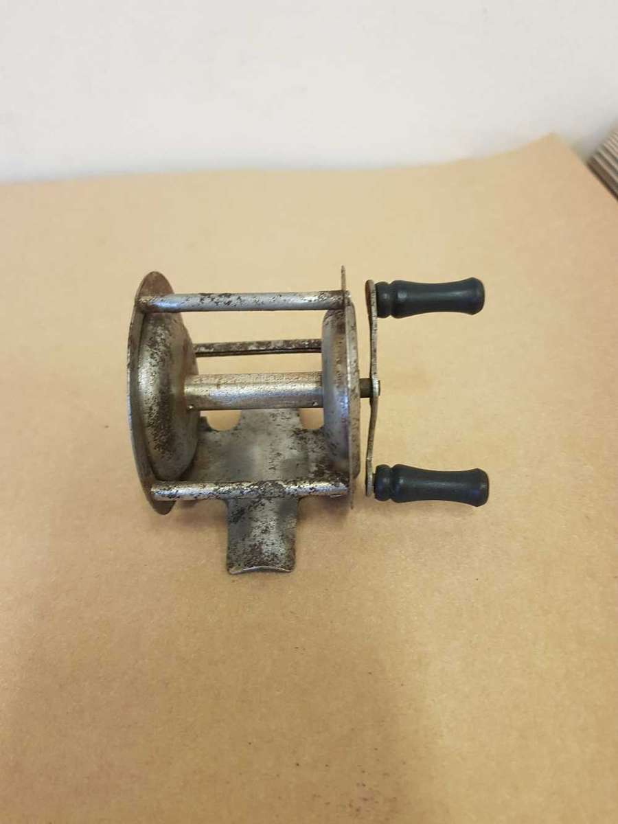 Vintage toy fishing reel.