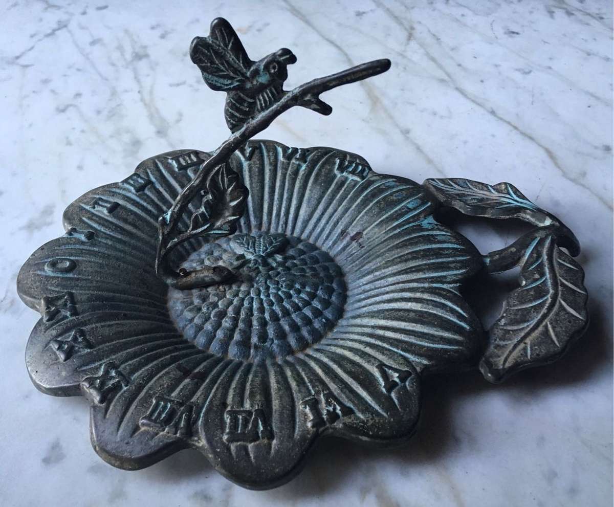 Vintage bronze sundial with dragonfly