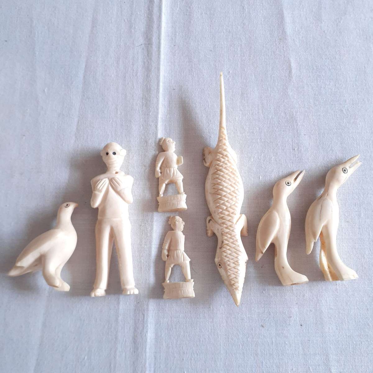 7 Little carved bone figurines birds and a crocodile