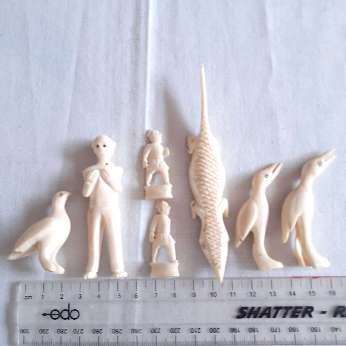 7 Little carved bone figurines birds and a crocodile